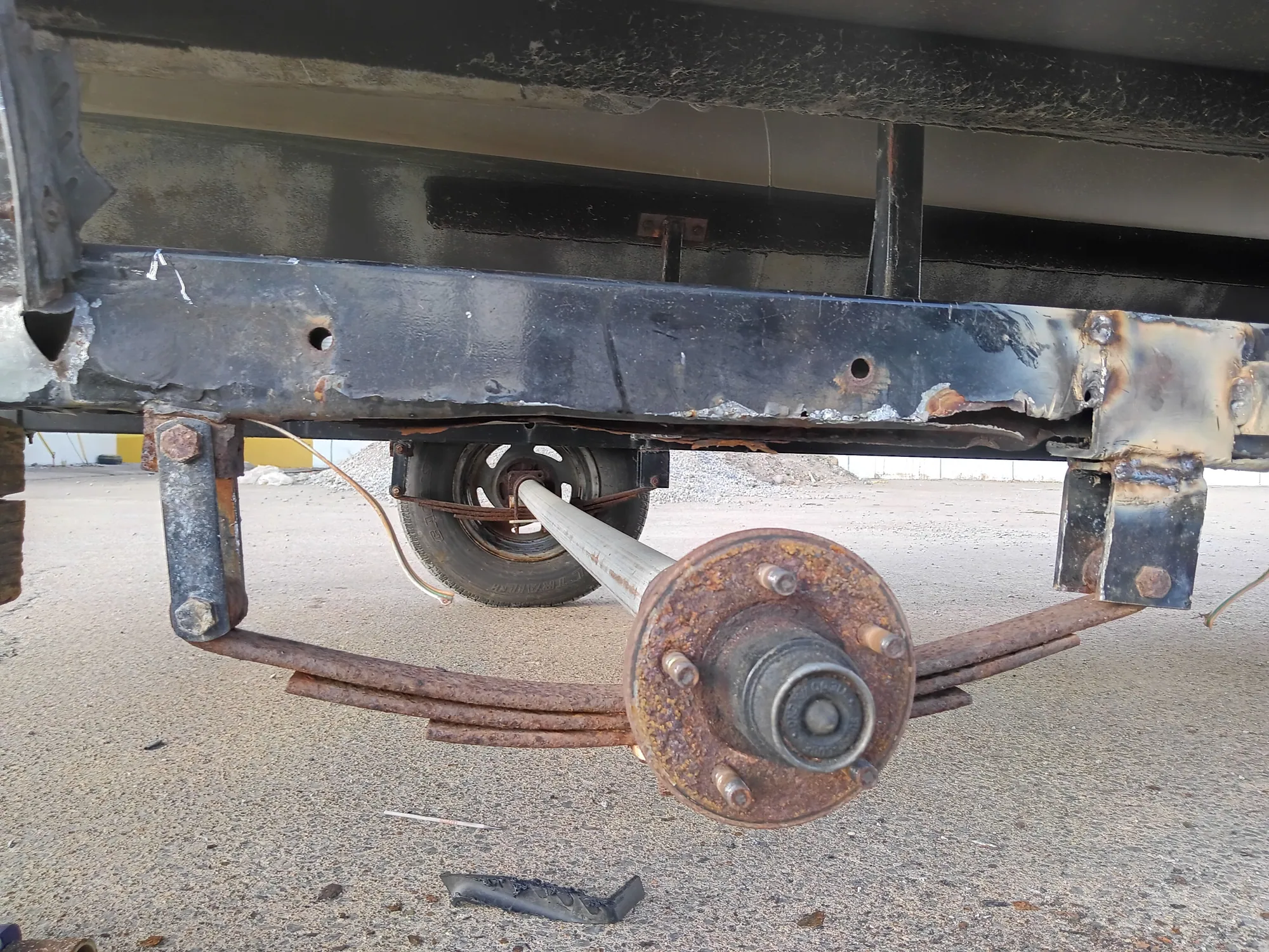 Trailer frame and axle exposed during structural welding repair